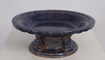 a blue bowl sitting on top of a white table
