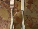 two forks and a knife on a table