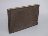 brown leather book with gold trim on a white background