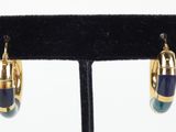 a close up of a pair of earrings on a stand