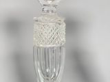 a glass candle holder with a candle on top of it