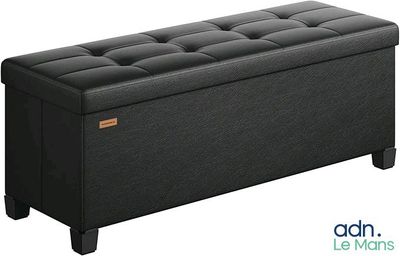 un banc de rangement noir avec un dessus capitonné et des pieds en bois