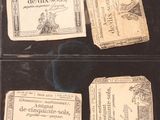 several old french currency cards are displayed in a display case