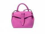 the small pink bag is on a white surface