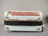 a white and red accordion sitting on top of a table
