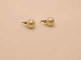 a pair of pearl earrings on a white surface