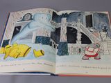 an open book with a picture of a snowman and a fish on it