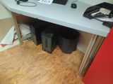 a desk with a computer and speakers on it