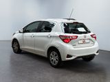 the back of a white toyota yaris parked in a white room