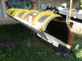 a yellow and black train that is sitting in the grass