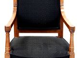 a black chair with a wooden frame and a black seat