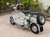 a scooter that is parked on the side of the road