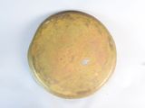 a yellow plate with a hole in it on a white surface