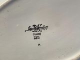 a close up of a white plate with a bird on it