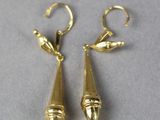 pair of gold plated earrings on a grey surface