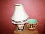 a lamp that is sitting on a table next to a bowl