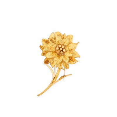 gold plated flower brooch with leaves on a white background