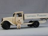 a toy truck with a man standing next to it
