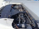a truck that has its hood open and the engine in the back