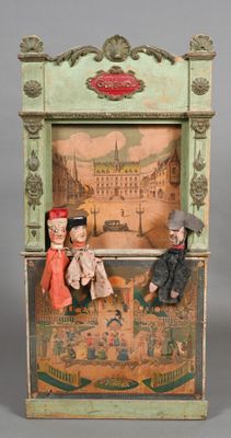 dolls sitting on a bench in front of a picture of a city