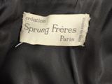 a close up of a label on a jacket that says creation spring freres paris