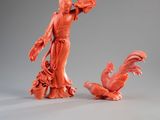 two figurines of a woman and a bird on a table