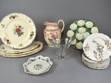 a lot of plates and cups and vases on the table
