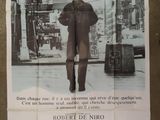 a poster of a man walking down the street