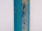 a book with a blue cover sitting on a white surface
