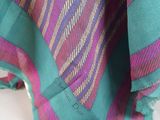 a close up of a colorful blanket on a white surface