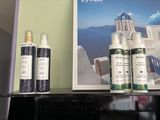 three bottles of perfume on a shelf next to a picture of a church