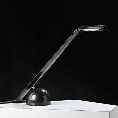 a black lamp that is sitting on a white table