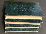 a stack of green books sitting on top of a table