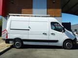 a white van that is parked in front of a building
