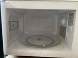 a white microwave that is open on the counter