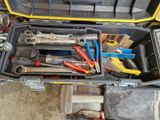 many tools in a tool box on the floor