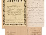 an old document with a handwritten letter on it next to a piece of paper