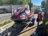 a red and black jet ski being pulled by a trailer