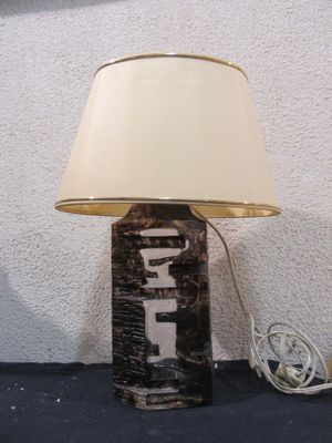 a lamp that is sitting on a table with a lamp shade on it