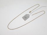 a close up of a necklace with a tag attached to it