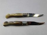 two knives that are sitting next to each other on a table
