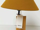 a lamp that is on a table with a book on it
