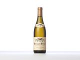 the bottle of white wine is sitting on the table