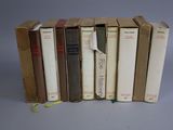several books are stacked on top of each other on a table