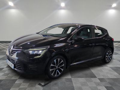 the black car is parked on a checkered floor in the garage
