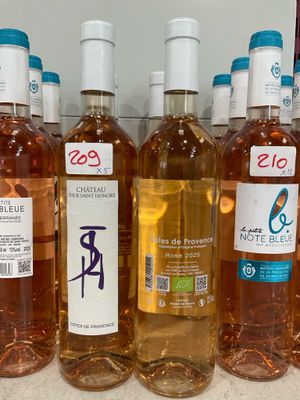 several bottles of wine are lined up on a counter