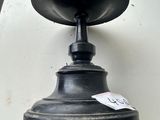 a close up of a black light fixture on a white wall