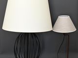 two lamps and a lamp shade on a table in a room