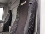 a seat in the back of a truck with a surfboard on it