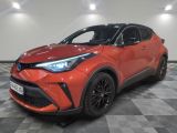 a red toyota c - hr suv parked on a checkered floor